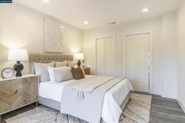 bedroom with dark hardwood / wood-style floors