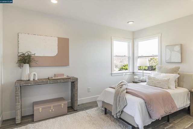 bedroom with dark hardwood / wood-style flooring