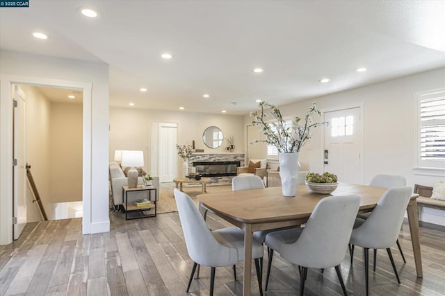 dining space featuring a fireplace and hardwood / wood-style floors