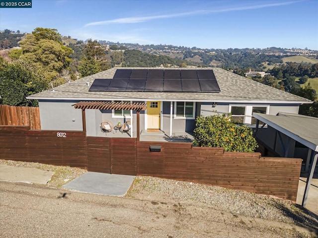 view of front facade featuring solar panels