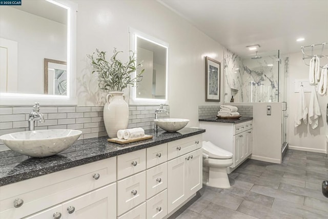 bathroom featuring backsplash, a shower with door, and vanity