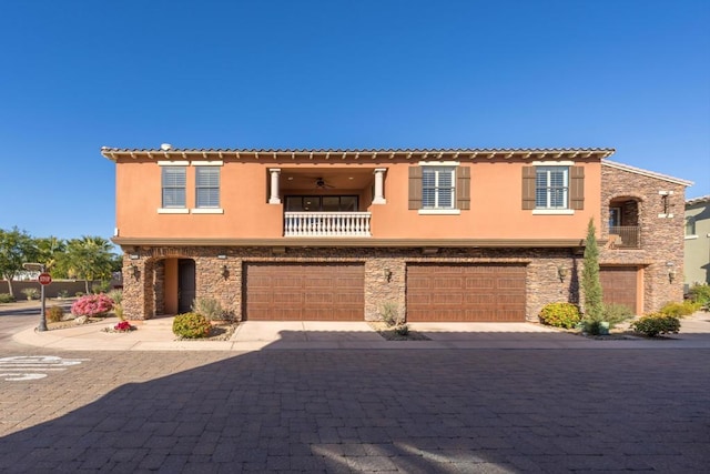 mediterranean / spanish house with a garage and a balcony