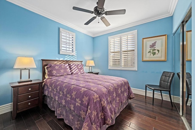 bedroom featuring ceiling fan, ornamental molding, dark hardwood / wood-style flooring, and a closet