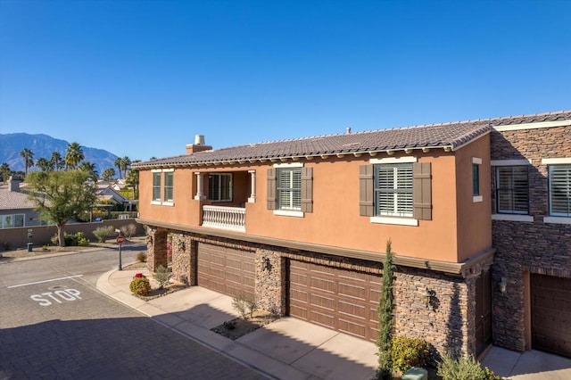 view of front of house with a garage and a mountain view