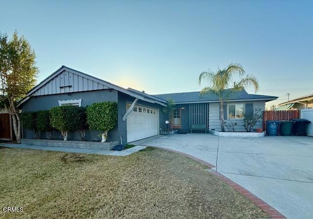 single story home featuring a garage and a front lawn