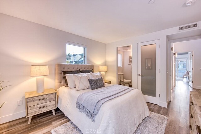 2618 Cove St, Corona Del Mar, CA 92625 - bedroom with baseboards, wood finished floors, and connected bathroom