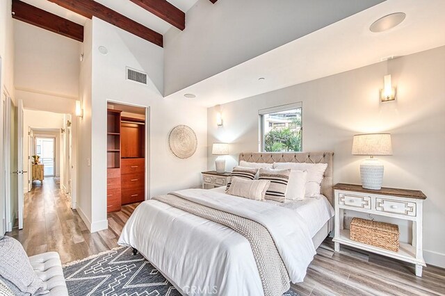 2618 Cove St, Corona Del Mar, CA 92625 - bedroom with beam ceiling, wood finished floors, baseboards, a closet, and a towering ceiling
