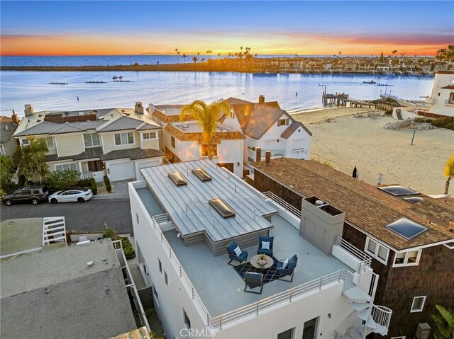 aerial view at dusk with a water view