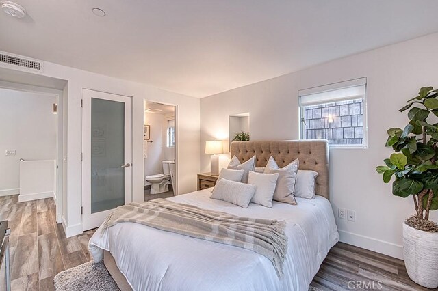 2618 Cove St, Corona Del Mar, CA 92625 - bedroom with wood finished floors, baseboards, and ensuite bath