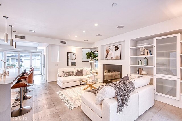 2618 Cove St, Corona Del Mar, CA 92625 - living area with built in features, light tile patterned flooring, recessed lighting, and a fireplace