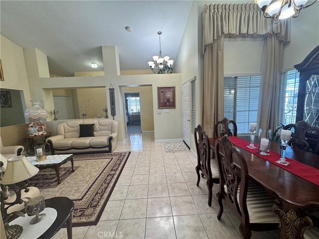 living room with a towering ceiling, light tile patterned flooring, and a notable chandelier