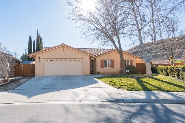 single story home featuring a front yard, a garage, and a mountain view