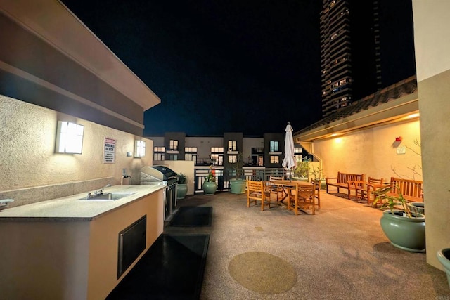 patio at twilight featuring grilling area, area for grilling, and sink