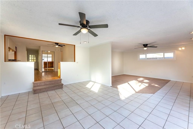 tiled spare room with a textured ceiling