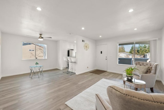 living room featuring ceiling fan and light wood-type flooring