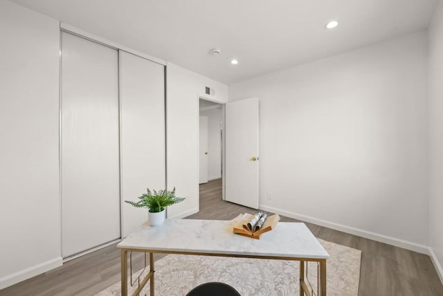 office space with wood-type flooring