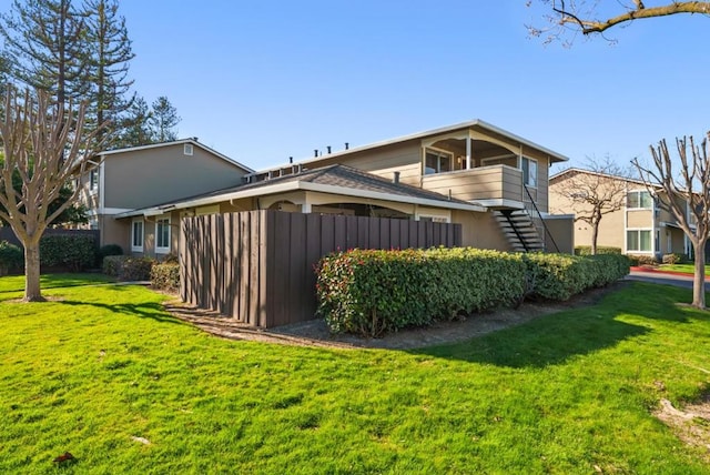 view of side of home with a yard