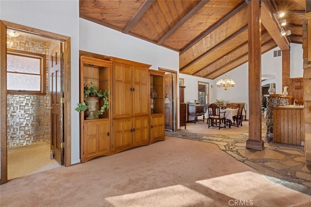 interior space featuring high vaulted ceiling, light carpet, a notable chandelier, and beamed ceiling