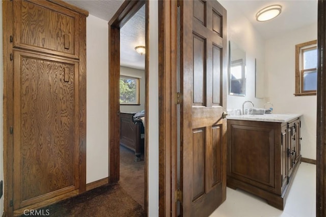 bathroom featuring a textured ceiling and vanity