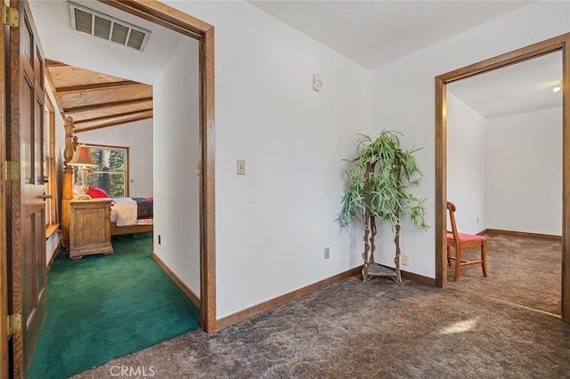 corridor featuring dark carpet and lofted ceiling with beams