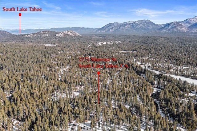 snowy aerial view featuring a mountain view