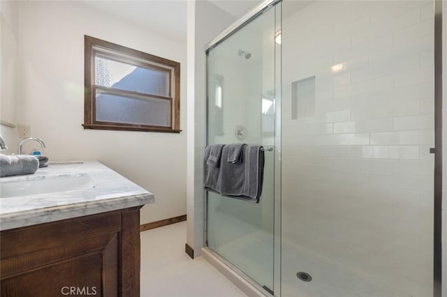 bathroom with vanity, tile patterned flooring, and a shower with door