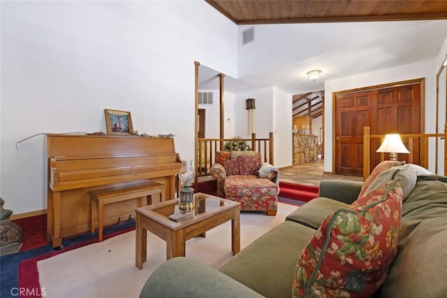 carpeted living room with high vaulted ceiling and wooden ceiling