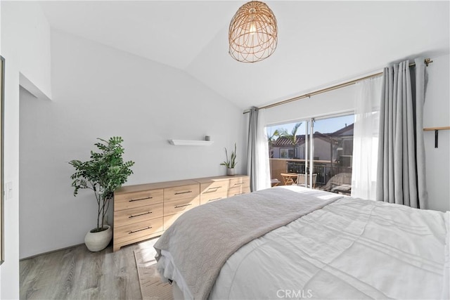 bedroom with light wood-type flooring, access to exterior, and vaulted ceiling