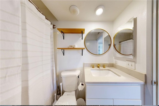 bathroom with toilet and vanity