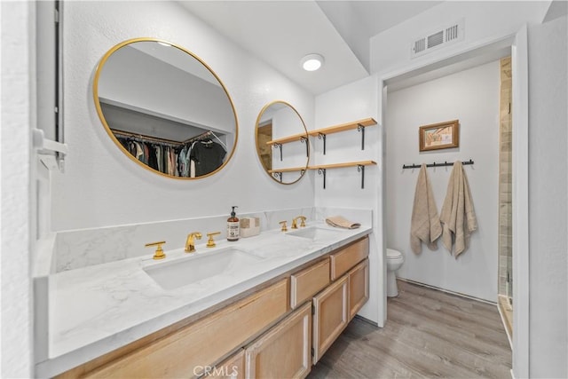 bathroom with hardwood / wood-style flooring, toilet, and vanity