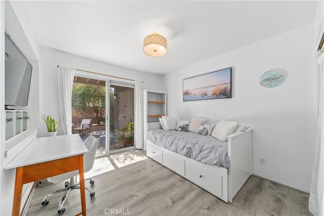 bedroom featuring light hardwood / wood-style floors and access to outside