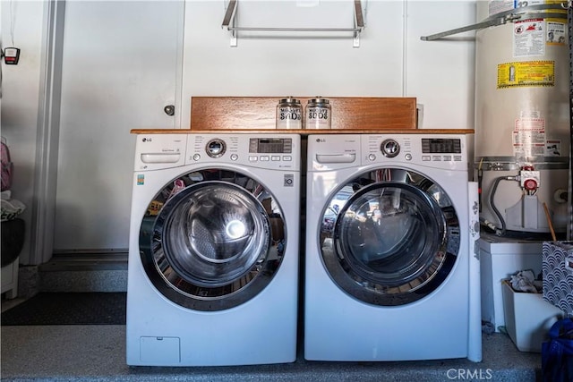 laundry room featuring washer and clothes dryer and water heater