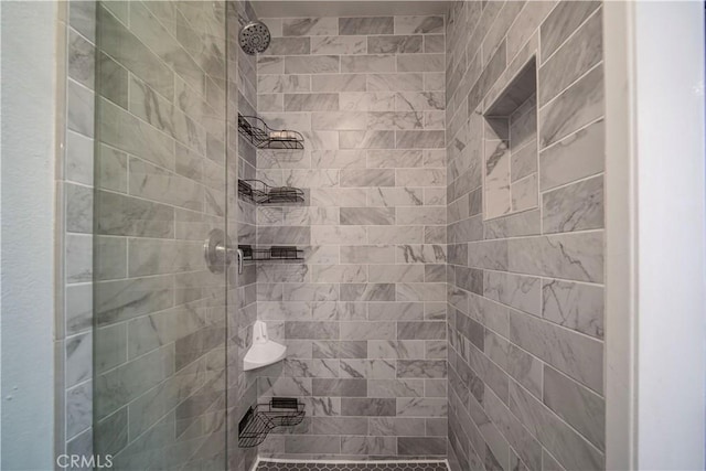 bathroom with tiled shower