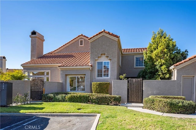 mediterranean / spanish home with a front yard