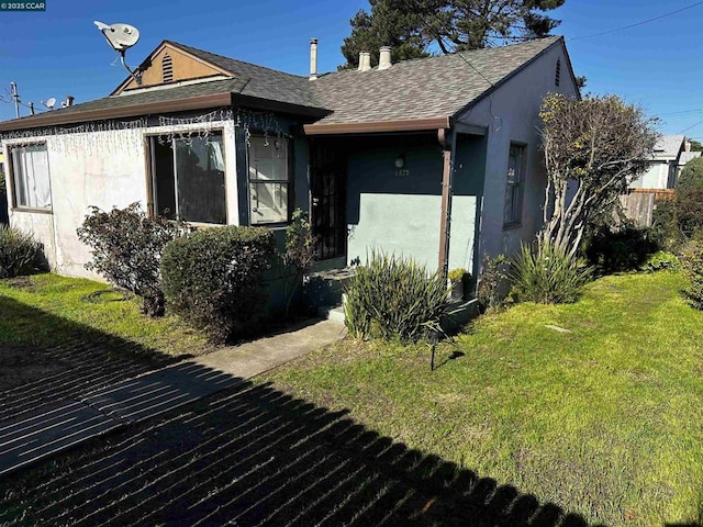 view of side of home featuring a yard