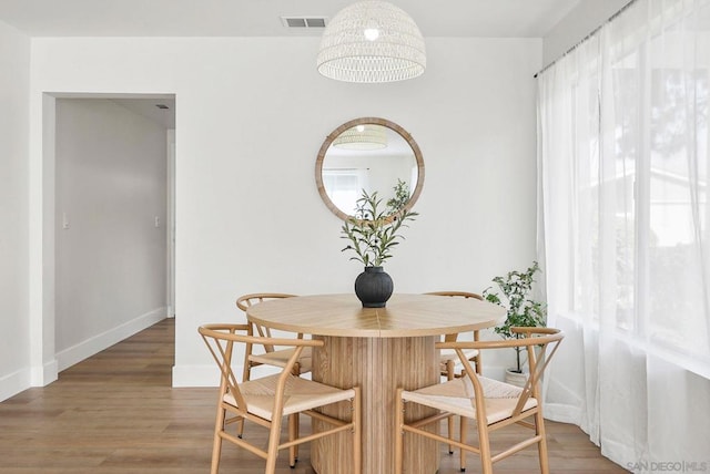 dining room featuring wood-type flooring and plenty of natural light