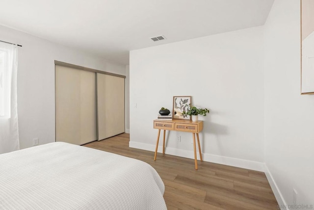 bedroom featuring a closet and light hardwood / wood-style flooring