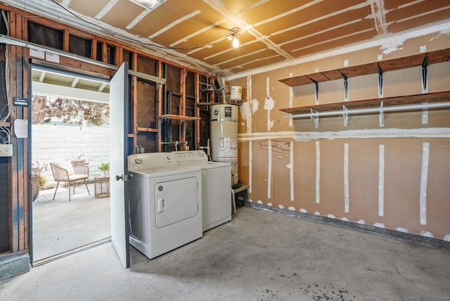 basement with water heater and washing machine and dryer