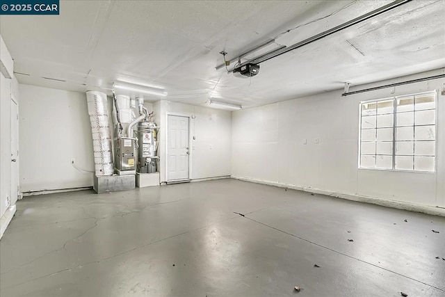 garage with heating unit, water heater, and a garage door opener