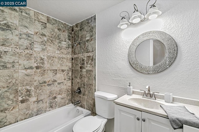 full bathroom featuring a textured ceiling, toilet, tiled shower / bath combo, and vanity