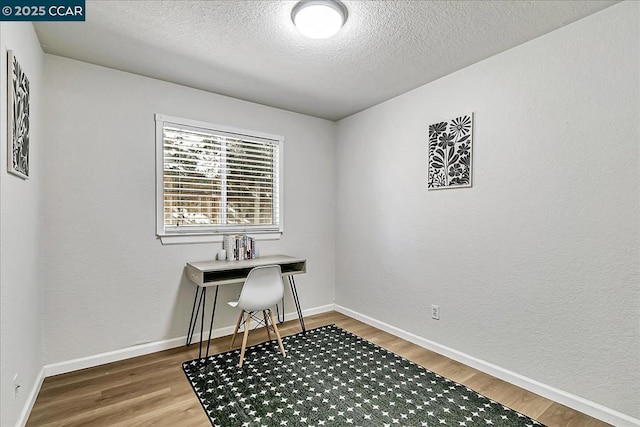 office space featuring a textured ceiling and hardwood / wood-style flooring