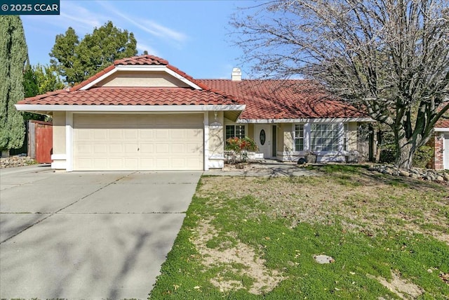 mediterranean / spanish house with a garage and a front lawn