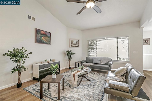 living room with ceiling fan, lofted ceiling, and light wood-type flooring