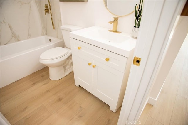 full bathroom featuring toilet, vanity, wood-type flooring, and  shower combination