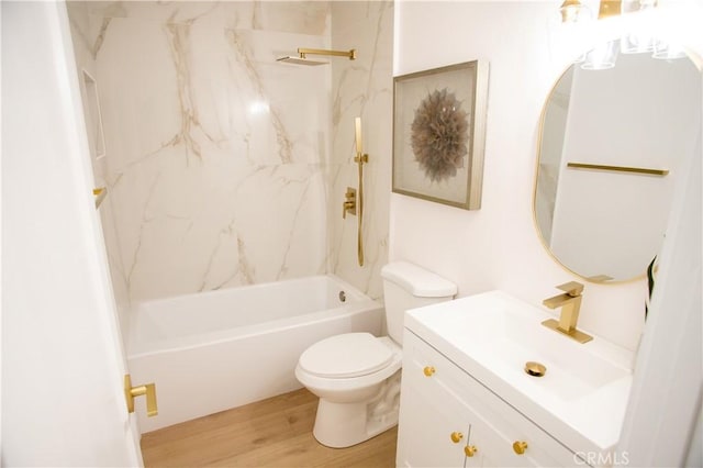 full bathroom featuring toilet, vanity, tiled shower / bath, and hardwood / wood-style floors