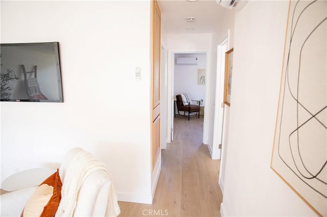 hall featuring a wall mounted AC and light hardwood / wood-style flooring