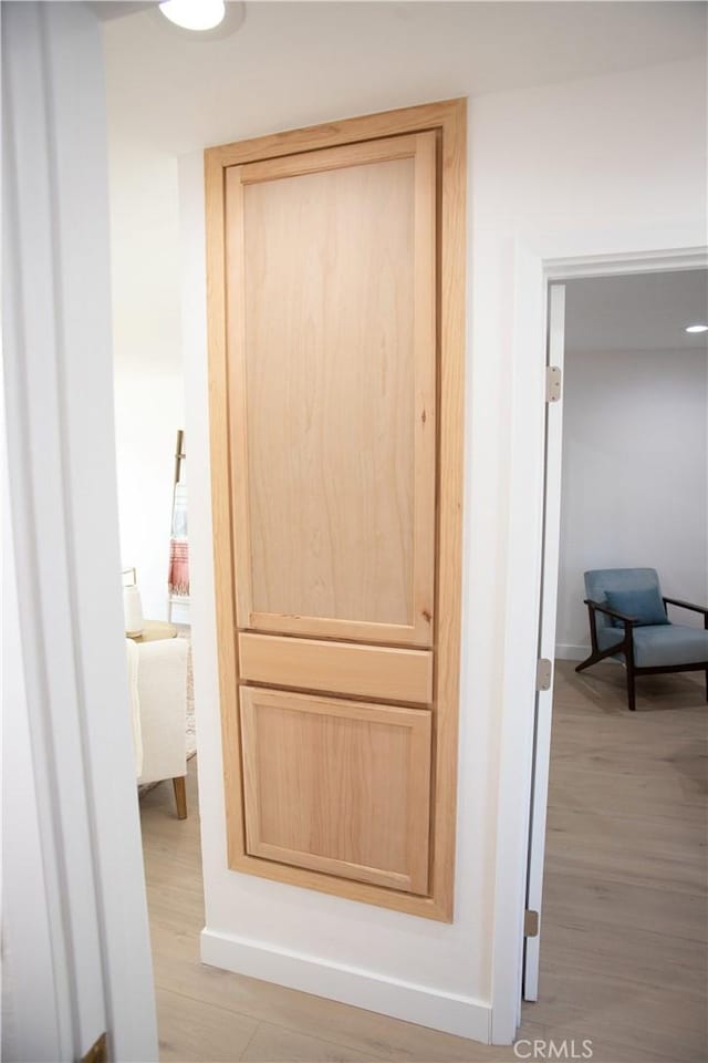 hallway with light hardwood / wood-style flooring