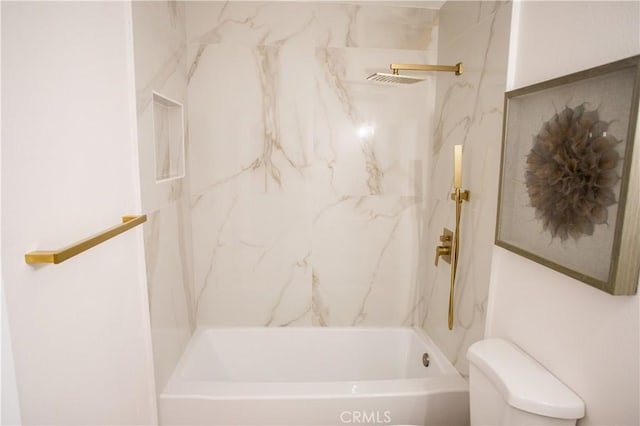 bathroom featuring toilet and tiled shower / bath