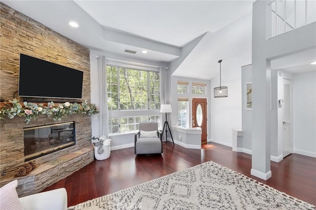 living room with dark wood-type flooring and a fireplace