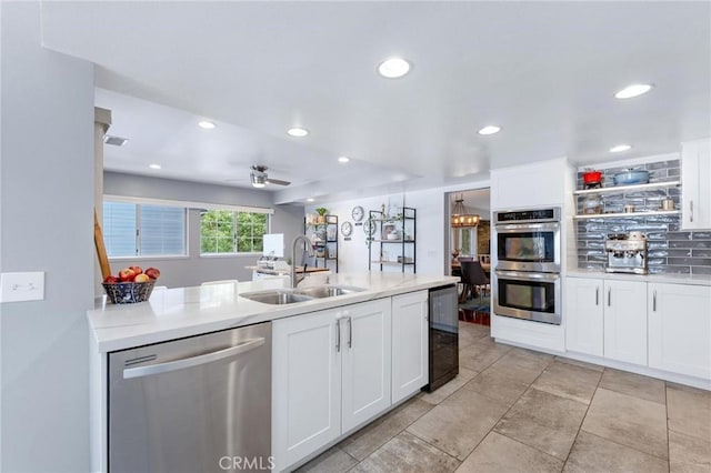 kitchen with ceiling fan, sink, white cabinets, and appliances with stainless steel finishes